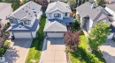 Contemporary two-story residence featuring a gray shingle roof, light-colored siding, and a prominent attached two-car garage - 2327 37B Avenue, Edmonton, AB 