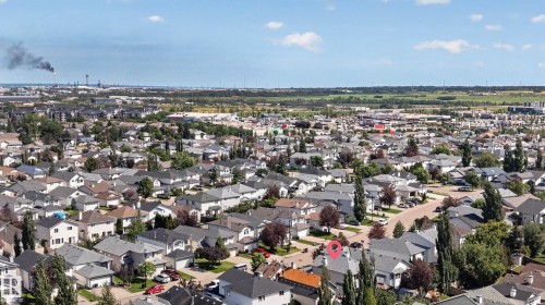 Residential neighborhood featuring detached homes with various rooflines and mature trees - 2327 37B Avenue, Edmonton, AB 