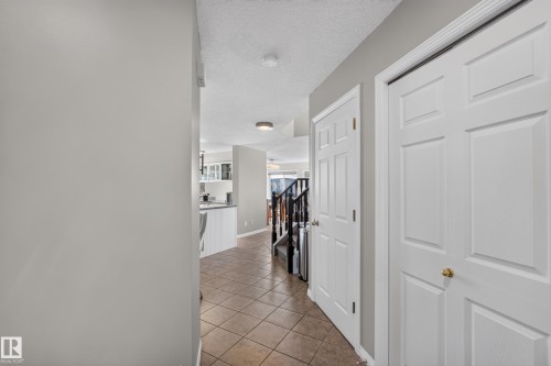 Entryway featuring neutral wall tones, white trim, and panel doors - 2327 37B Avenue, Edmonton, AB 
