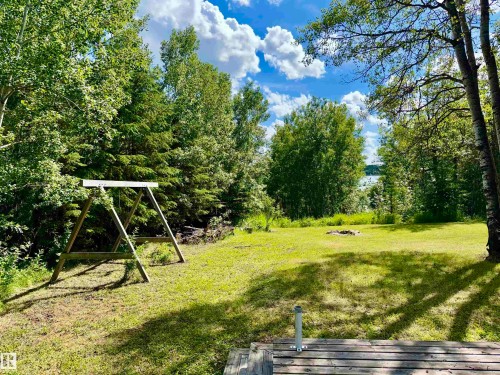Expansive grassy yard with mature trees and a trail to the lake - 208 60118 Secondary Highway 867, Rural St. Paul County, AB - Outdoor