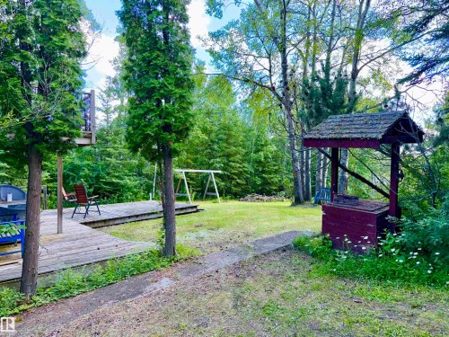 Expansive yard featuring a wooden deck, established trees - 208 60118 Secondary Highway 867, Rural St. Paul County, AB - Outdoor