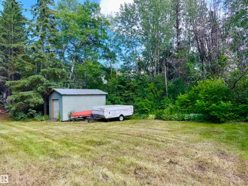 Expansive grassy area featuring a detached utility shed - 208 60118 Secondary Highway 867, Rural St. Paul County, AB - Outdoor