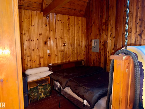 Tongue and groove wood paneling throughout, featuring a vaulted wood-finish ceiling and exposed beam - 208 60118 Secondary Highway 867, Rural St. Paul County, AB - Indoor