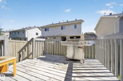 Expansive outdoor deck featuring wood flooring and a perimeter railing - 