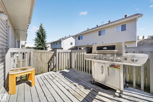 Outdoor wood deck featuring a wooden railing and stairs - 59 2503 24 Street, Edmonton, AB 