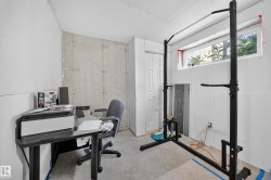 Unfinished interior space featuring a concrete accent wall and a window - 