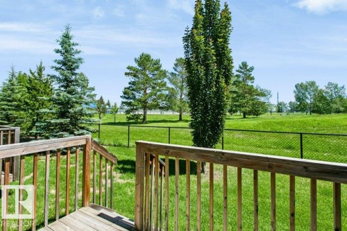 Wooden deck area with balusters, overlooking a grassy expanse - 27 4205 30 Street, Edmonton, AB 
