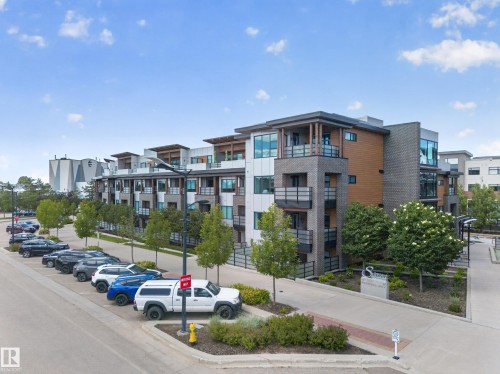 Modern multi-story building featuring varied facade materials including brick, vertical wood-finish siding, and white paneling - Sherwood Park, AB 
