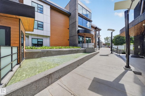 Modern architectural design featuring varied facade materials including wood-finish siding and expansive glazing - Sherwood Park, AB 