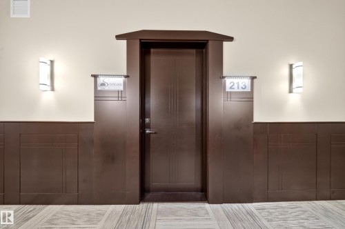 Dark wood-paneled door with an ornate frame - Sherwood Park, AB 
