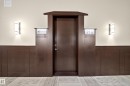 Dark wood-paneled door with an ornate frame - Sherwood Park, AB 