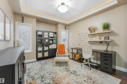 Recessed ceiling with perimeter lighting and a central flush-mount fixture - 1231 Tredger Crest, Edmonton, AB 