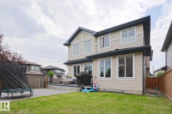 Expansive backyard featuring a green lawn and a large composite deck - 