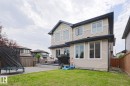 Expansive backyard featuring a green lawn and a large composite deck - 1304 Ainslie Wynd, Edmonton, AB 