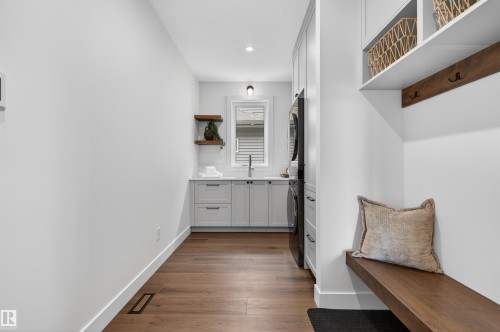 Mudroom featuring a built-in bench, overhead shelving, and coat hooks - 149 Eastgate Way, St. Albert, AB 