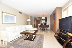 Open-concept living area featuring light-toned flooring throughout - 
