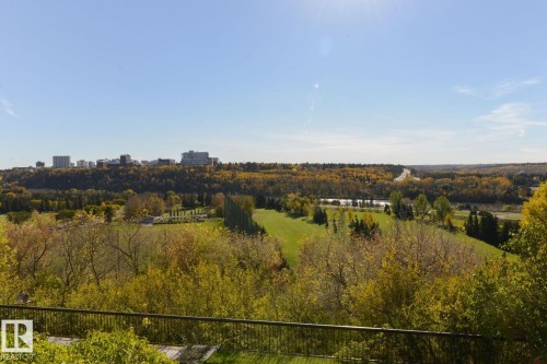 Expansive natural landscape featuring lush green spaces, mature trees, a distant river, and a city skyline on the horizon - 1805 10011 123 Street, Edmonton, AB 