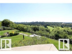 Expansive property featuring a terraced lawn, established landscaping, and a stepping stone pathway - 