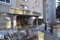 "The Gainsborough" building entrance featuring a covered portico, decorative columns, and a stone walkway - 