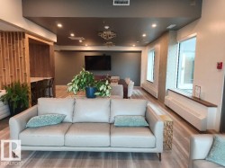 Open-concept common area featuring wood-finish flooring, recessed lighting, and large windows - 