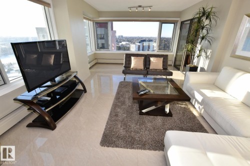 Expansive windows with city and water scenery, complemented by light-toned, high-gloss flooring - 1805 10011 123 Street, Edmonton, AB 