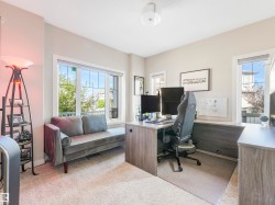 Bright main-floor office or versatile flex room, filled with natural light thanks to an extra window. - 
