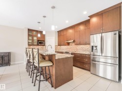 Enjoy upgraded floor-to-ceiling kitchen cabinets featuring soft-close drawers and elegant under-cabinet lighting. - 