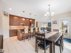 Spacious dining area with sweeping views of the expansive backyard and seamless access to your immaculate outdoor space. - 