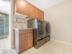Convenient upper-floor full laundry room with a dedicated sink, accessible directly from both the primary ensuite and the hallway — no more lugging laundry up and down the stairs. - 