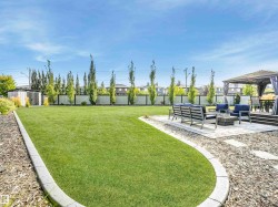 A stunning private backyard sanctuary — professionally landscaped and impeccably maintained. - 
