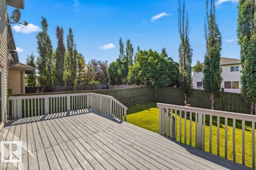 Spacious outdoor deck with railings overlooking a fenced backyard - 2407 Hagen Way, Edmonton, AB 