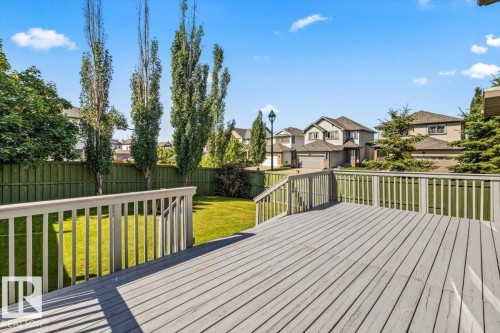Spacious outdoor deck featuring light gray wood-finish decking and perimeter railing - 2407 Hagen Way, Edmonton, AB 