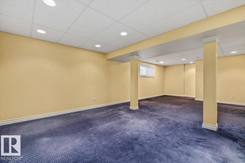 Finished lower level featuring recessed lighting, a drop ceiling, and broadloom carpeting - 2407 Hagen Way, Edmonton, AB 