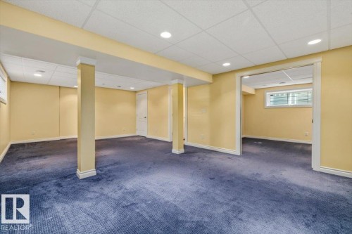 Spacious lower level featuring recessed lighting, a drop ceiling, and a large open entry to an additional room - 2407 Hagen Way, Edmonton, AB 