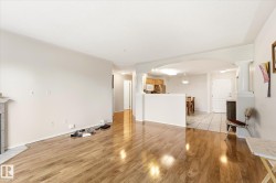 Expansive living space featuring wood-finish flooring - 