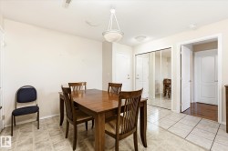 Tiled flooring featuring a ceiling-mounted light fixture and white interior doors - 