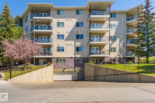 Multi-story building exterior featuring numerous private balconies with glass railings - #310 237 Youville Dr E Nw, Edmonton, AB - Outdoor With Balcony With Facade