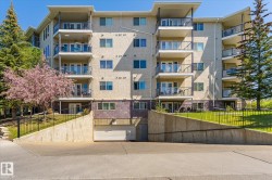Multi-story building exterior featuring numerous private balconies with glass railings - 