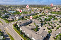 Aerial perspective showcasing a residential development with multiple multi-story apartment buildings and single-story structures - 