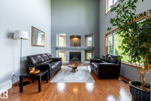 Vaulted ceiling and huge windows overlooking the golf course make this a special living area. Includes wood flooring and a contemporary fireplace - 114 Reichert Drive, Beaumont, AB 