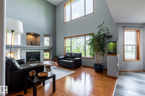Vaulted living area featuring a tile-surround fireplace with a mantel - 114 Reichert Drive, Beaumont, AB 