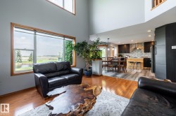 Living area with high ceilings and hardwood flooring - 
