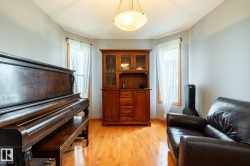 Hardwood flooring throughout featuring light gray walls; could serve as a formal dining area - 