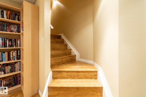 Staircase into basement featuring wood-finish treads and white risers - 114 Reichert Drive, Beaumont, AB 