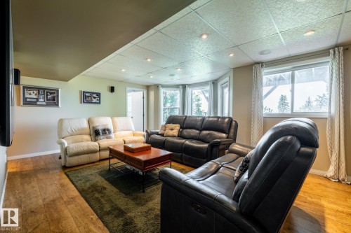 Walkout basement includes a beautiful family room with wood-finish flooring and lots of windows - 114 Reichert Drive, Beaumont, AB 