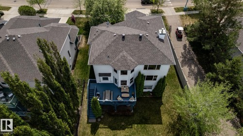 Rear exterior featuring a multi-level deck, white siding, and an asphalt shingle roof - 114 Reichert Drive, Beaumont, AB 