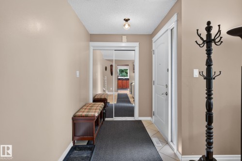 Foyer entrance featuring a white paneled door, light neutral wall paint, and overhead lighting - 31 Alpine Boulevard, St. Albert, AB 