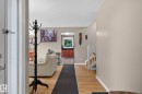 Foyer featuring hardwood flooring, neutral wall tones, and a staircase with white balusters - 31 Alpine Boulevard, St. Albert, AB 