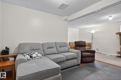 Finished basement space featuring light-toned walls, a textured ceiling, and recessed lighting - 31 Alpine Boulevard, St. Albert, AB 