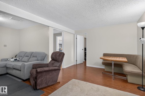 Wood-finish flooring throughout, featuring a built-in banquette with a wood-finish tabletop - 31 Alpine Boulevard, St. Albert, AB 